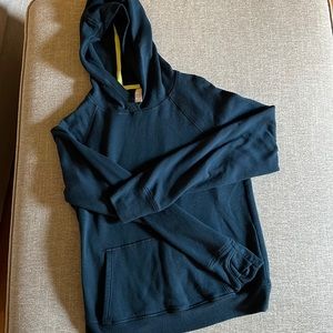 Navy blue Athleta girl sweatshirt, warm with thumb pockets, has hood, L/12